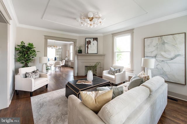 110 Varnum St NW, Washington, DC 20011 - living room featuring a chandelier, wood finished floors, crown molding, baseboards, and a fireplace