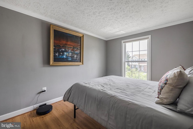 6402 Devonshire Ln, Frederick, MD 21703 - bedroom featuring wood finished floors, baseboards, a textured ceiling, and ornamental molding