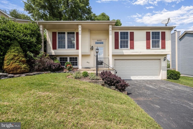 6402 Devonshire Ln, Frederick, MD 21703 - bi-level home with driveway, a garage, and a front yard