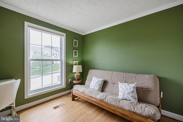 6402 Devonshire Ln, Frederick, MD 21703 - sitting room with ornamental molding, wood finished floors, baseboards, and a textured ceiling