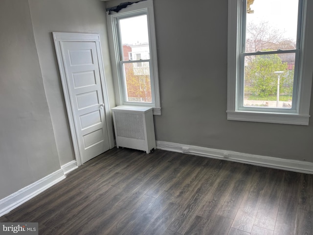 3414 Cardenas Ave, Baltimore, MD 21213 - unfurnished room with radiator, dark wood-type flooring, baseboards, and plenty of natural light