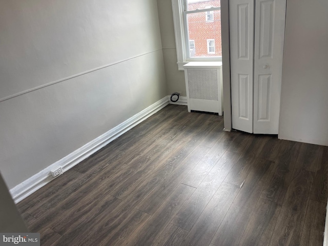 3414 Cardenas Ave, Baltimore, MD 21213 - unfurnished bedroom featuring radiator, dark wood-style flooring, and baseboards