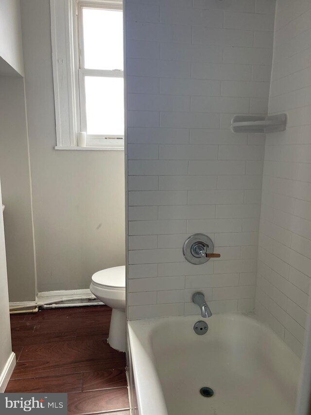 3414 Cardenas Ave, Baltimore, MD 21213 - full bathroom featuring wood finished floors, toilet, baseboards, and shower / bathtub combination
