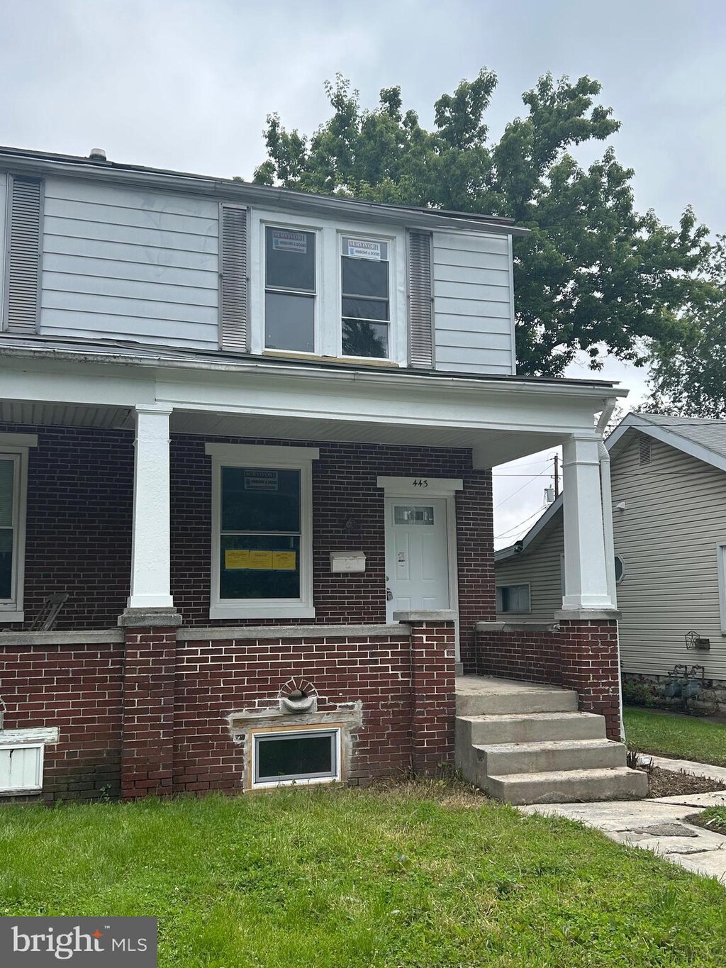 443 N 2nd St, Wormleysburg, PA 17043 - view of front facade with covered porch and brick siding