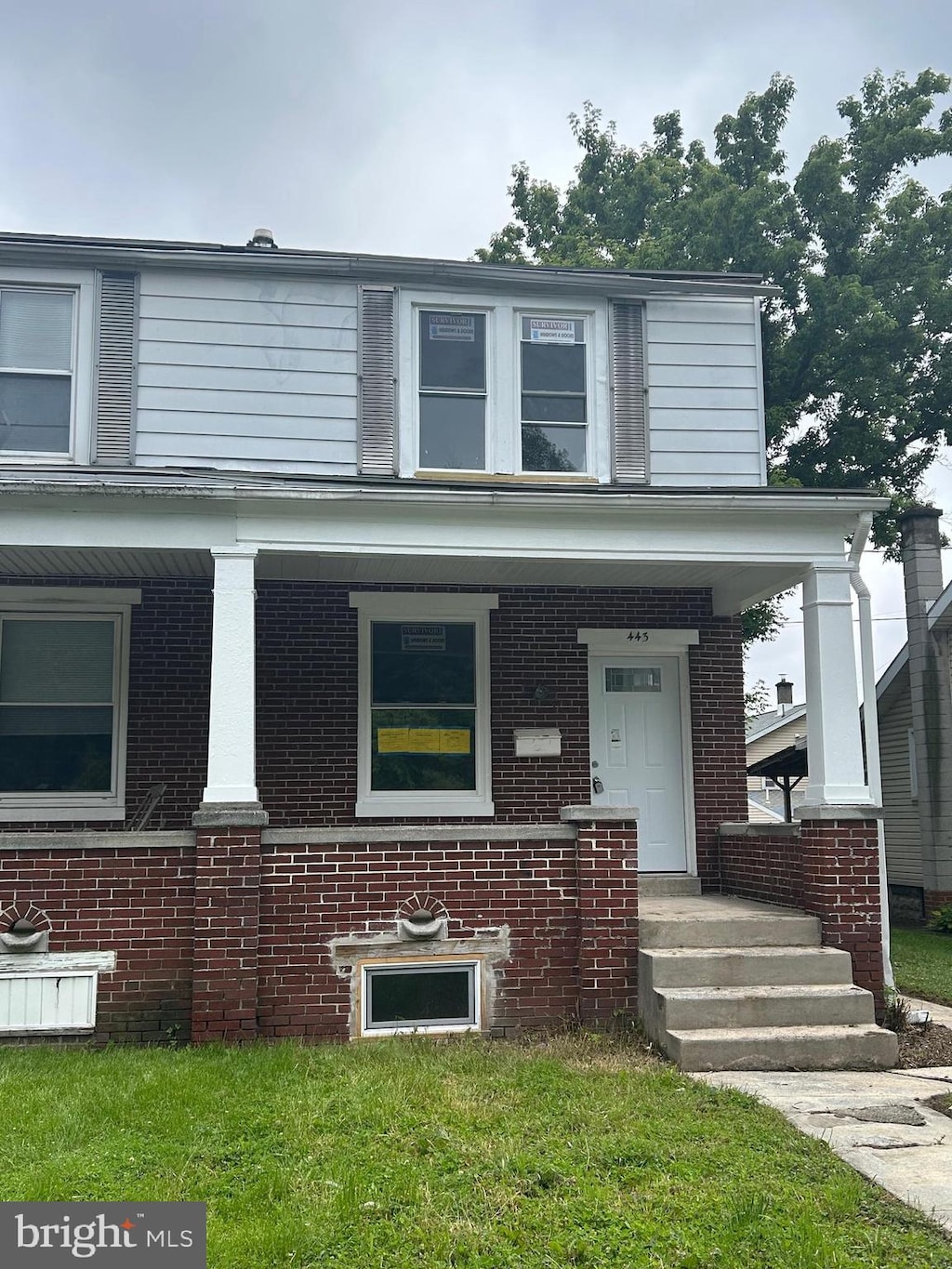 443 N 2nd St, Wormleysburg, PA 17043 - view of front facade featuring covered porch and brick siding
