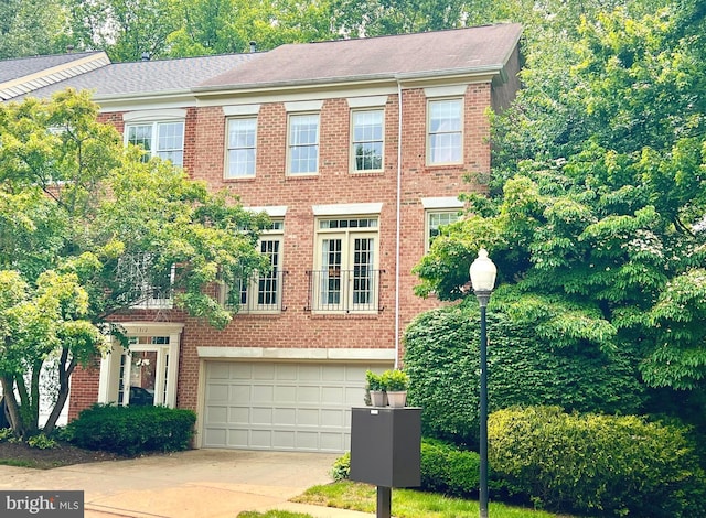 1310 Sundial Dr, Reston, VA 20194 - view of front of house featuring a garage, brick siding, and driveway