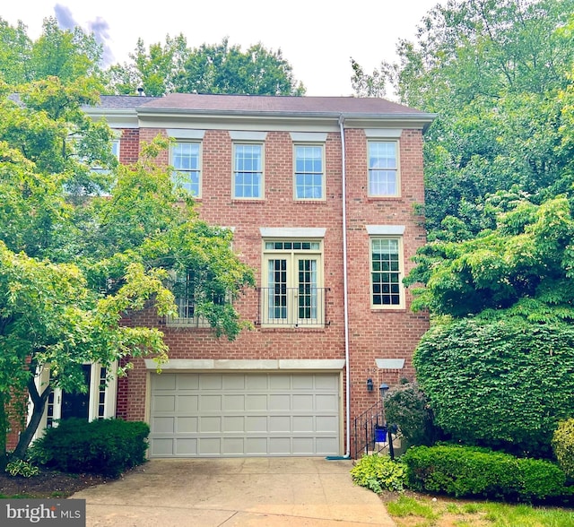 1310 Sundial Dr, Reston, VA 20194 - view of front of home with driveway, an attached garage, and brick siding