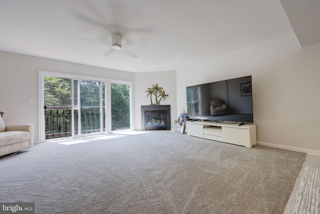 17455 Kagera Dr, Dumfries, VA 22025 - living room featuring ceiling fan, light colored carpet, and a glass covered fireplace