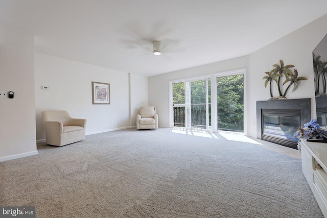 17455 Kagera Dr, Dumfries, VA 22025 - sitting room featuring a ceiling fan, a glass covered fireplace, carpet flooring, and baseboards