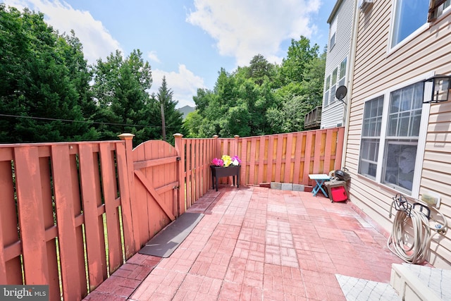 17455 Kagera Dr, Dumfries, VA 22025 - fenced backyard with a gate and a patio area