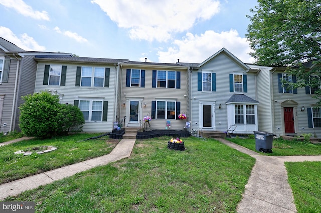 17455 Kagera Dr, Dumfries, VA 22025 - townhome / multi-family property with a front lawn
