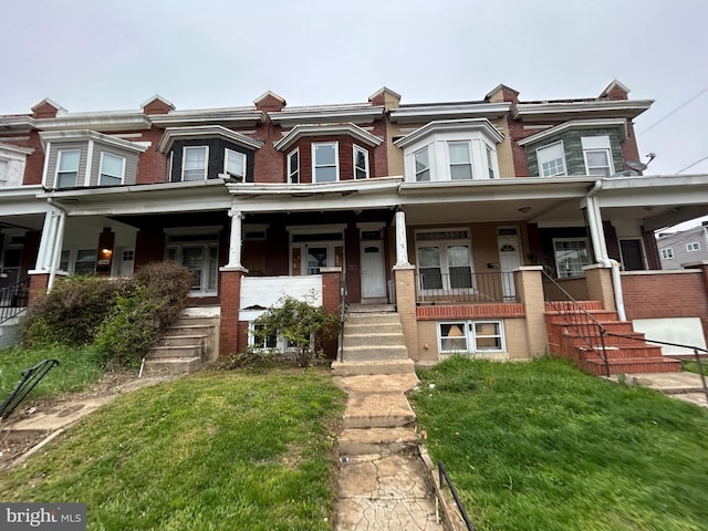 2904 Winchester St, Baltimore, MD 21216 - townhome / multi-family property with a porch, stairs, and brick siding