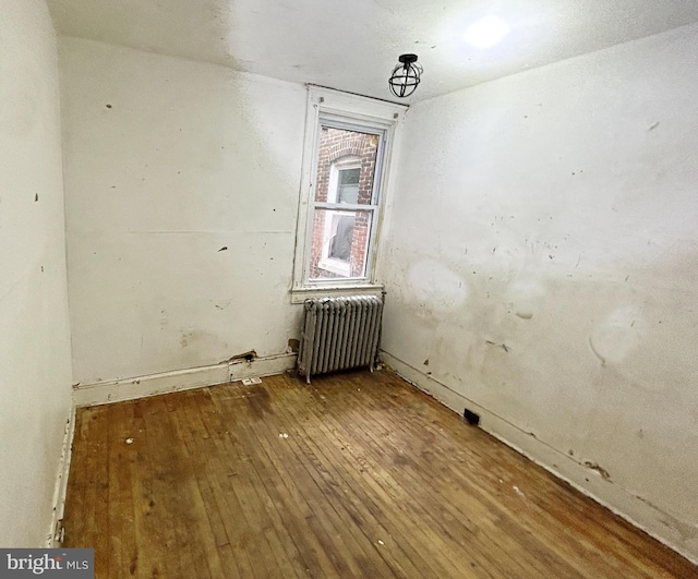 2904 Winchester St, Baltimore, MD 21216 - empty room with radiator and hardwood / wood-style floors