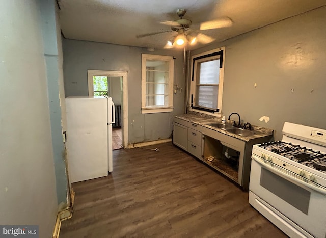 2904 Winchester St, Baltimore, MD 21216 - kitchen with white appliances, a sink, ceiling fan, and dark wood-style flooring