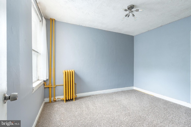 2014 N 4th St, Philadelphia, PA 19122 - carpeted empty room with radiator heating unit and baseboards