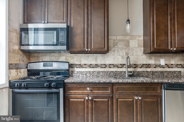 2014 N 4th St, Philadelphia, PA 19122 - kitchen featuring appliances with stainless steel finishes, a sink, dark brown cabinets, and tasteful backsplash