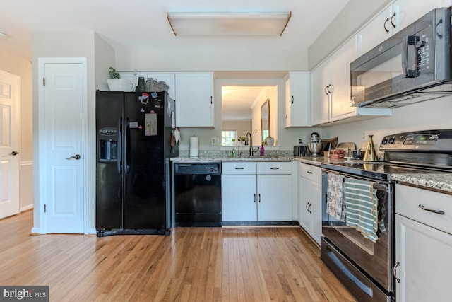 6150 Castletown Way, Alexandria, VA 22310 - kitchen with black appliances, light wood-style floors, and white cabinets