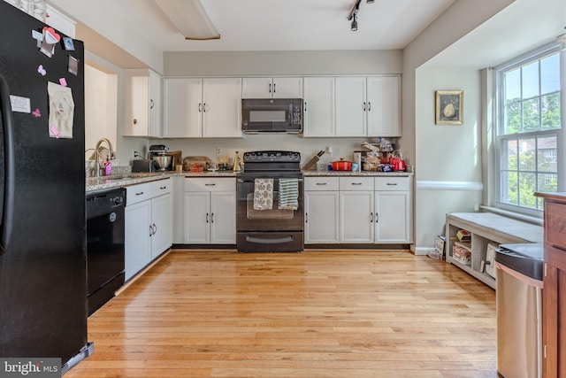6150 Castletown Way, Alexandria, VA 22310 - kitchen featuring black appliances, white cabinetry, light wood-style flooring, and healthy amount of natural light