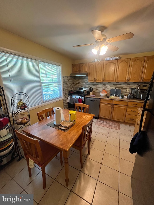 7001 Kepner Ct, Lanham, MD 20706 - kitchen featuring stainless steel gas stove, under cabinet range hood, dishwashing machine, light tile patterned flooring, and tasteful backsplash
