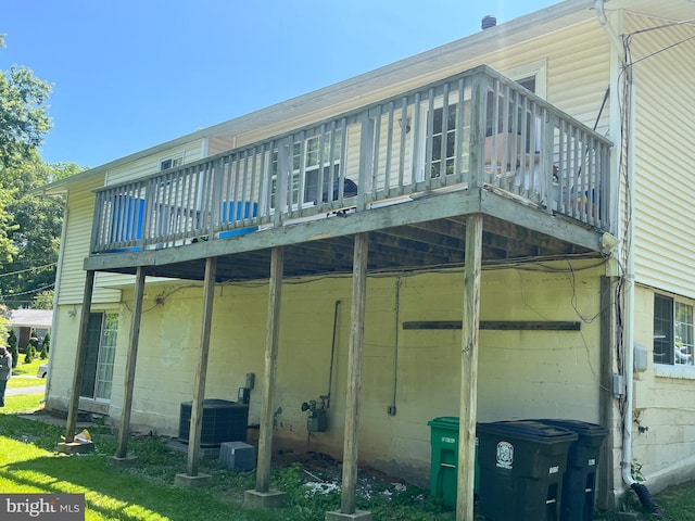 7001 Kepner Ct, Lanham, MD 20706 - rear view of house featuring central AC unit, a wooden deck, and concrete block siding