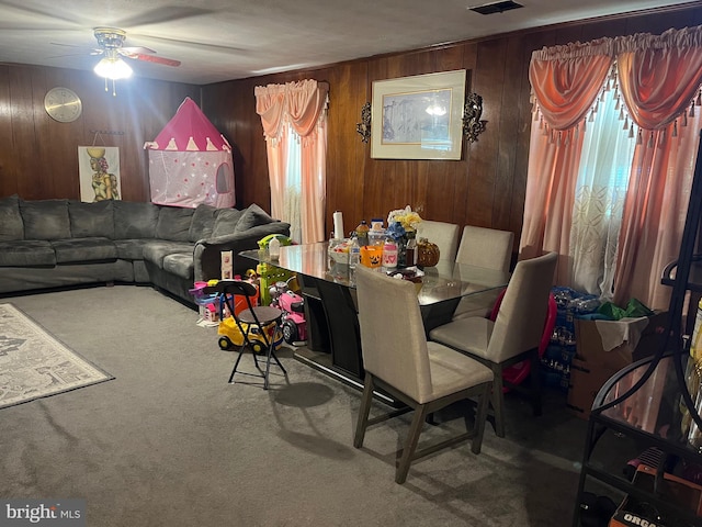 7001 Kepner Ct, Lanham, MD 20706 - carpeted living room with ceiling fan, wood walls, and plenty of natural light