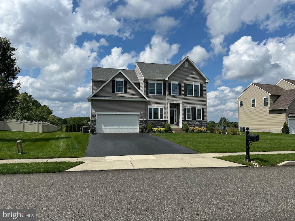 112 Lois Ln, Hammonton, NJ 08037 - view of front facade featuring stone siding, an attached garage, and asphalt driveway