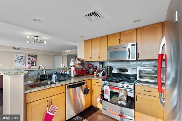 414 Water St Unit 1112, Baltimore, MD 21202 - kitchen featuring appliances with stainless steel finishes, a peninsula, a sink, backsplash, and light brown cabinetry