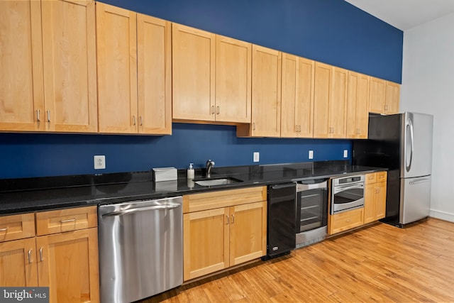 414 Water St Unit 1112, Baltimore, MD 21202 - kitchen with appliances with stainless steel finishes, light brown cabinets, beverage cooler, a sink, and dark countertops