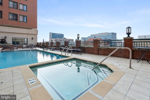 414 Water St Unit 1112, Baltimore, MD 21202 - community pool featuring a hot tub and a patio area