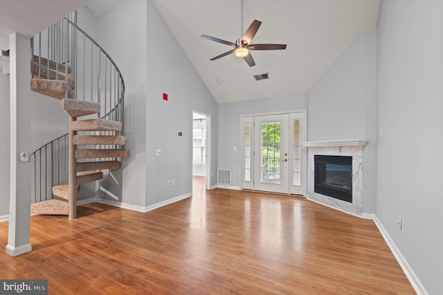 2000 Phillips Ter Unit 12, Annapolis, MD 21401 - unfurnished living room featuring wood finished floors, a ceiling fan, stairs, high vaulted ceiling, and a premium fireplace