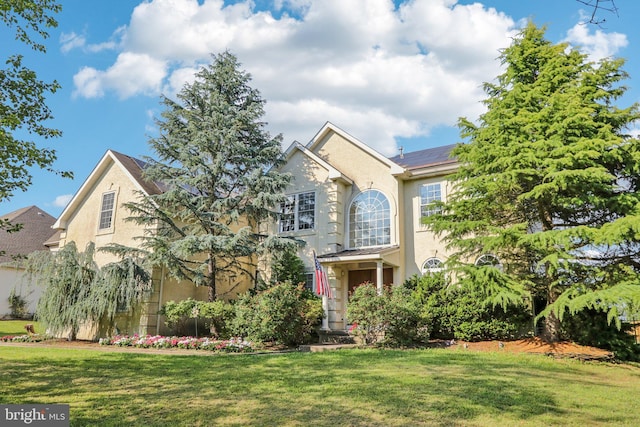 148 Ryans Run, Sicklerville, NJ 08081 - traditional-style home with stucco siding, a front lawn, and roof mounted solar panels