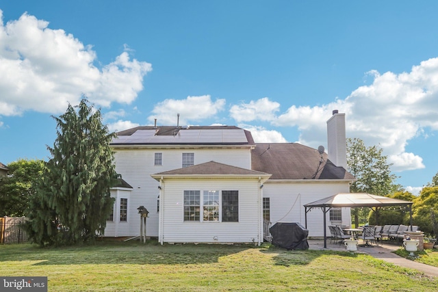 148 Ryans Run, Sicklerville, NJ 08081 - rear view of house featuring a gazebo, a patio, roof mounted solar panels, a detached carport, and a chimney