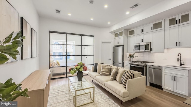 2517 Ontario Rd NW Unit 5, Washington, DC 20009 - living room with light wood-type flooring and recessed lighting