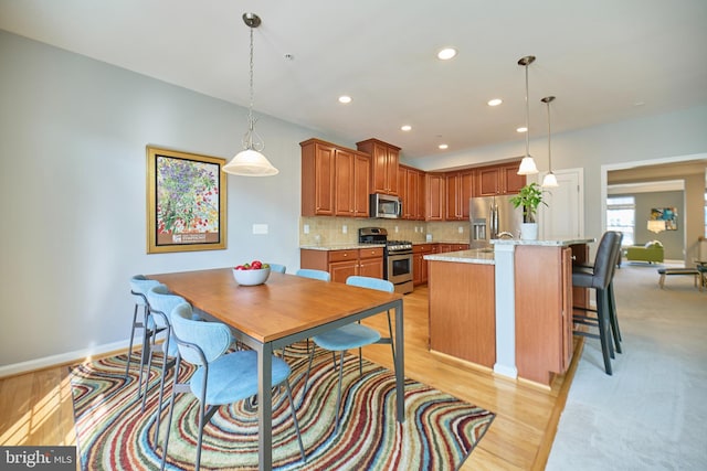 21623 Romans Dr, Ashburn, VA 20147 - kitchen with appliances with stainless steel finishes, backsplash, recessed lighting, baseboards, and decorative light fixtures