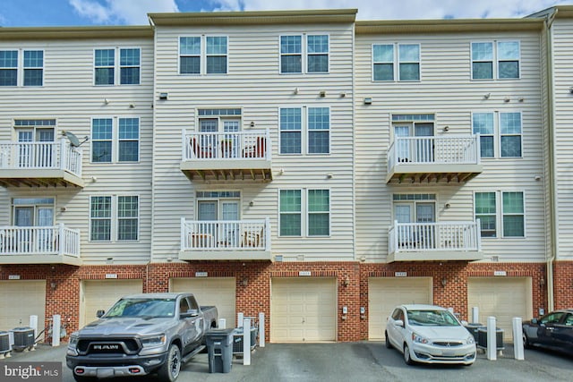 21623 Romans Dr, Ashburn, VA 20147 - view of building exterior featuring a garage, driveway, and central AC unit