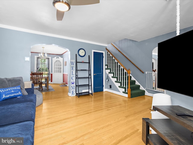 1016 Elm Rd, Halethorpe, MD 21227 - living area with arched walkways, a ceiling fan, stairway, wood finished floors, and crown molding
