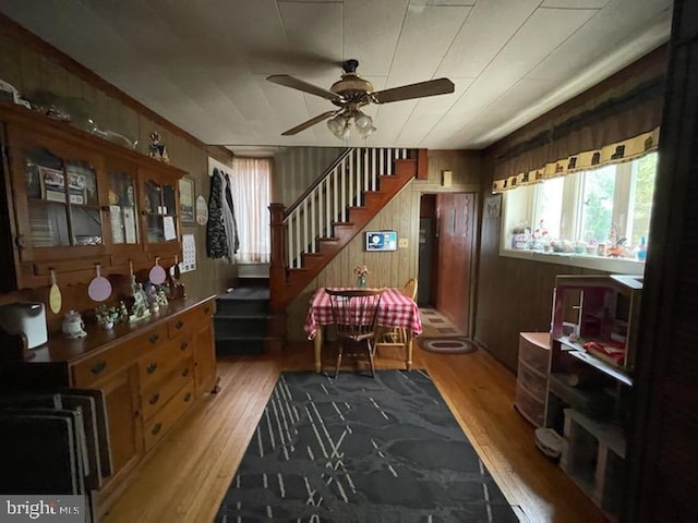 319 Linden St, Reading, PA 19604 - sitting room with ceiling fan, wood finished floors, stairs, and wood walls