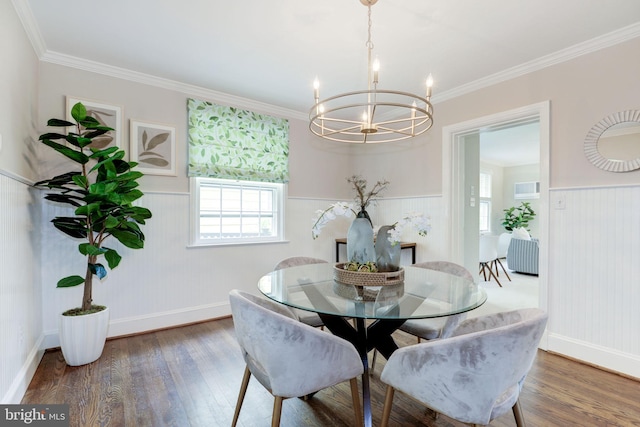 3703 Thornapple St, Chevy Chase, MD 20815 - dining area featuring a chandelier, wood finished floors, healthy amount of natural light, a wainscoted wall, and crown molding