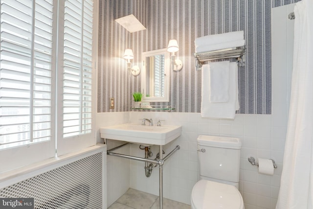3703 Thornapple St, Chevy Chase, MD 20815 - bathroom featuring wallpapered walls, radiator, toilet, and tile walls