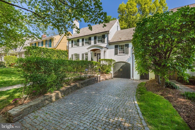3703 Thornapple St, Chevy Chase, MD 20815 - colonial home with decorative driveway, brick siding, and a carport