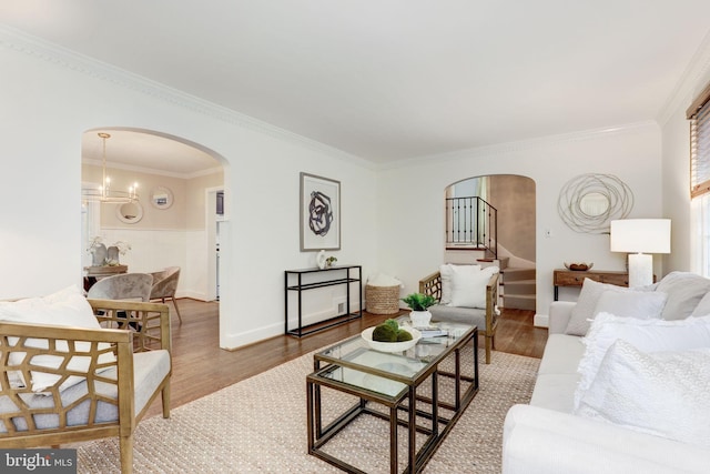 3703 Thornapple St, Chevy Chase, MD 20815 - living area featuring arched walkways, wood finished floors, crown molding, and a chandelier