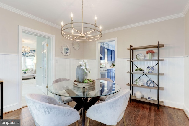 3703 Thornapple St, Chevy Chase, MD 20815 - dining area with a chandelier, a wainscoted wall, ornamental molding, and wood finished floors