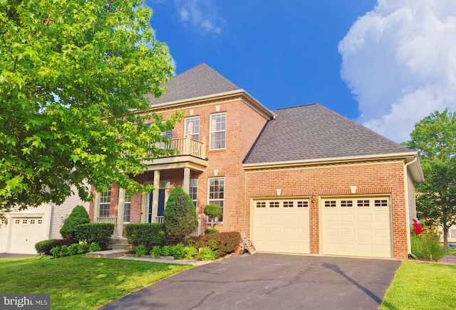 35547 Sarasota St, Round Hill, VA 20141 - colonial home featuring driveway, a garage, brick siding, a balcony, and a front yard