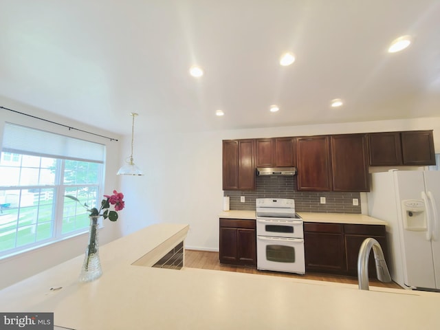 35547 Sarasota St, Round Hill, VA 20141 - kitchen featuring white appliances, under cabinet range hood, light countertops, dark brown cabinets, and recessed lighting