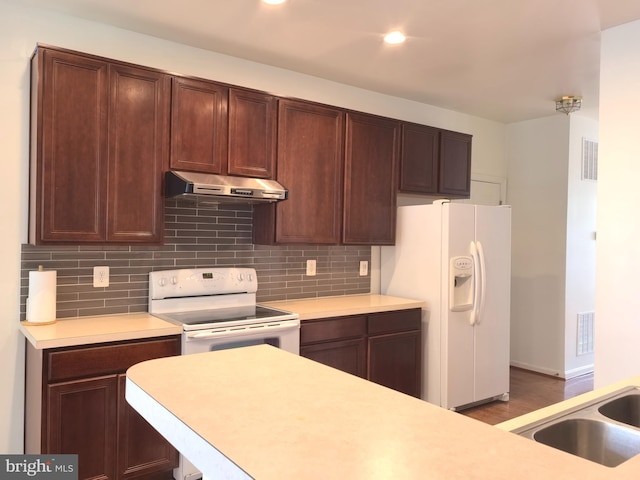 35547 Sarasota St, Round Hill, VA 20141 - kitchen with white appliances, under cabinet range hood, light countertops, backsplash, and recessed lighting