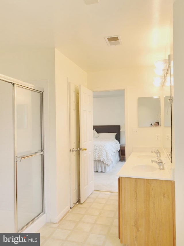 35547 Sarasota St, Round Hill, VA 20141 - full bath featuring double vanity, tile patterned floors, connected bathroom, and a shower with door