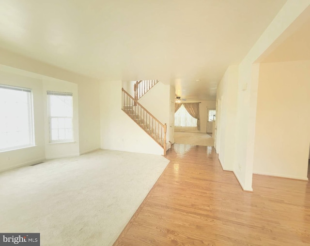 35547 Sarasota St, Round Hill, VA 20141 - unfurnished living room with stairs, light wood finished floors, and baseboards