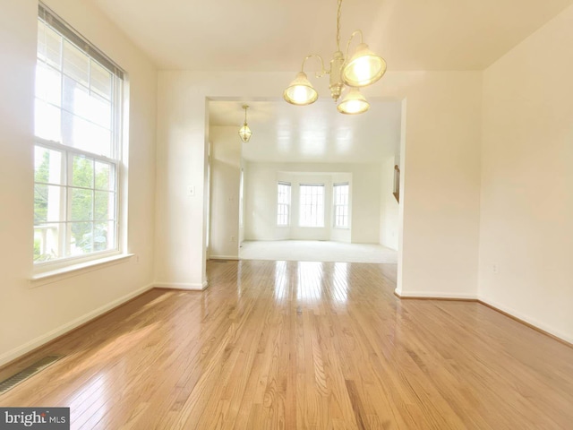 35547 Sarasota St, Round Hill, VA 20141 - spare room featuring a chandelier, light wood-style flooring, and baseboards
