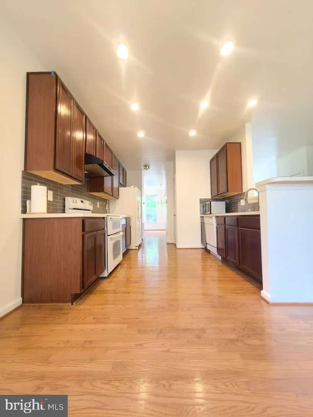 35547 Sarasota St, Round Hill, VA 20141 - kitchen with white appliances, light wood-style floors, decorative backsplash, under cabinet range hood, and recessed lighting