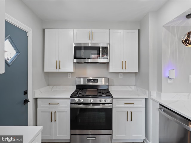 610 Galveston Pl SE, Washington, DC 20032 - kitchen featuring stainless steel appliances, white cabinets, and light stone counters